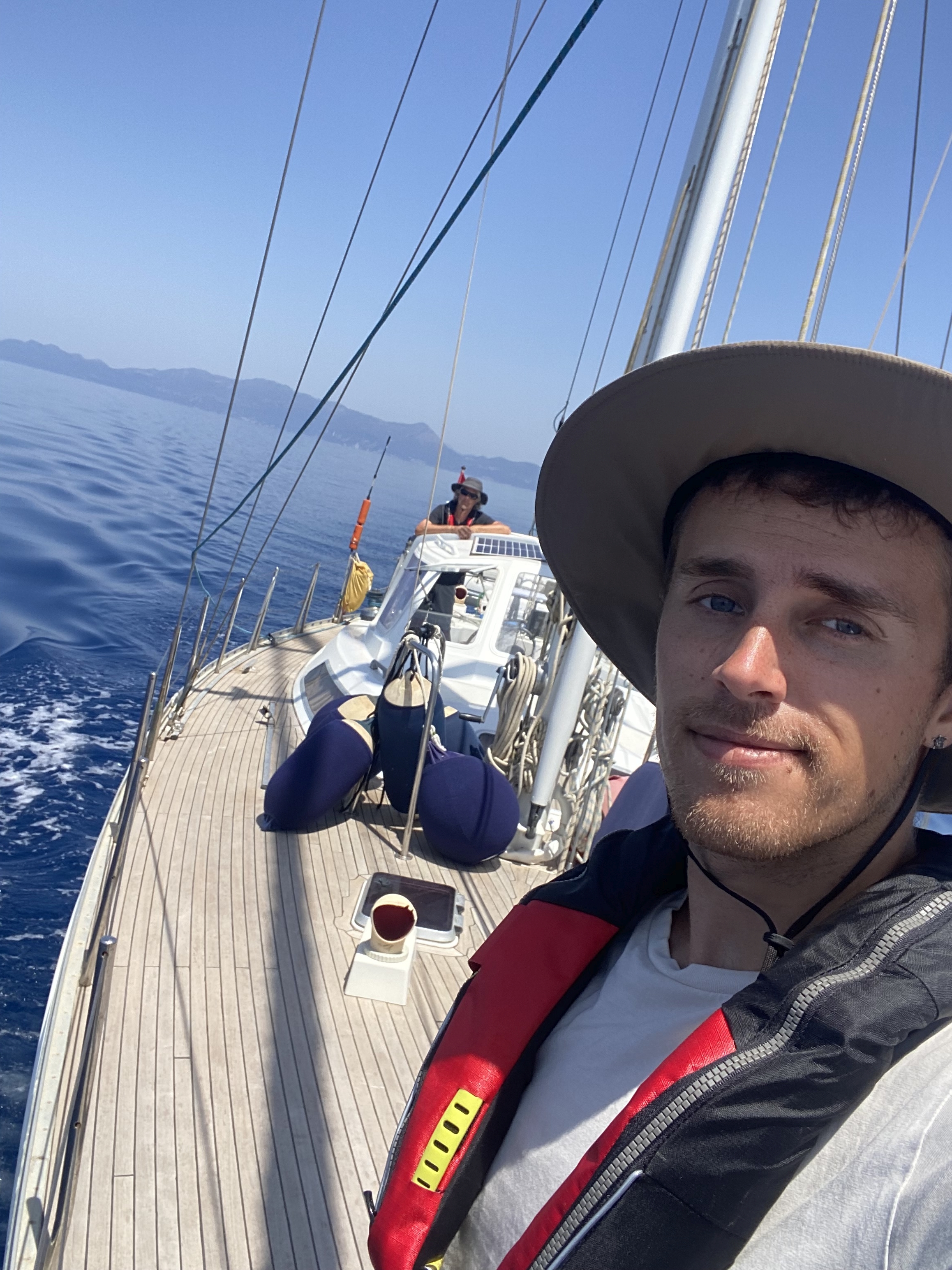 Selfie on deck with the vivid blue water of the Ionian Sea behind